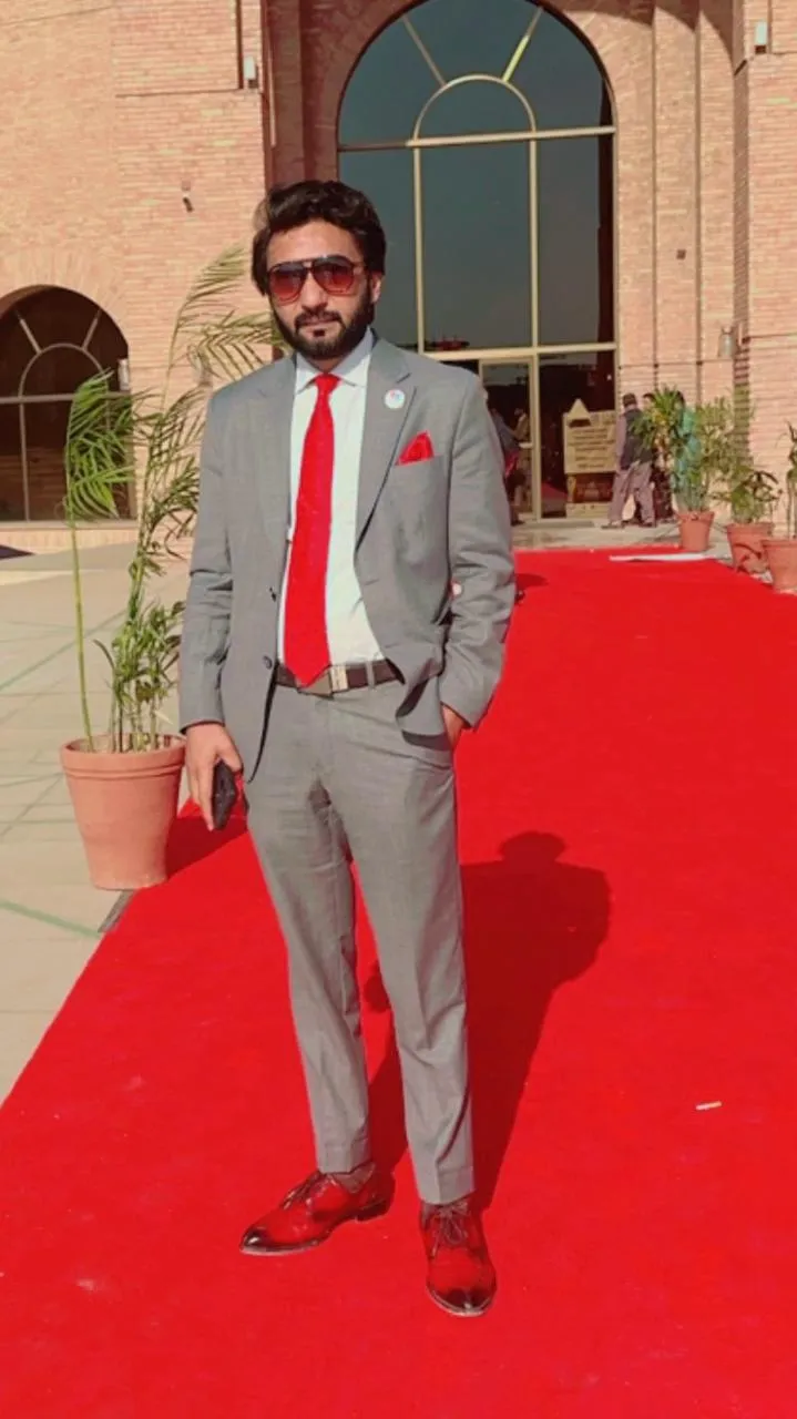 Qaiser Standing at an event